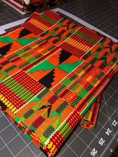 Ankara Fabric 100% cotton, Double-sided Material: 100% Cotton Width: 46"" The vibrancy and intensity of this piece is real, highly potent.  The colors just pop out!  This high quality Kente fabric is 100% cotton with intense hues of orange, red, black, and green.  A classic pattern, with a new zest and excellence.  Perfect for clothing, quilting, pillows or crafts, double sided and 46"" wide.  All Ankara is cut to order, and is sold by the yard.  African fabric is processed and folded on the app Traditional Patterned Cotton Fabric For Festivals, Cotton Fabric With Vibrant Multicolor Print, Multicolor Cotton Fabric With Vibrant Print, Vibrant Multicolor Cotton Fabric, Traditional Multicolor Cotton Fabric, Multicolor Traditional Pattern Cotton Fabric, Multicolor Cotton Fabric For Festivals, Traditional Cotton Fabric With Geometric Pattern, Multicolor Cotton Fabric With Traditional Patterns