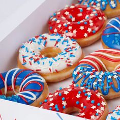 a box filled with donuts covered in red, white and blue sprinkles