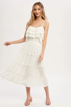 Make a timeless statement in this stunning midi dress. Crafted from the finest materials, this glamorous piece is adorned with classic off-white swiss dot detailing and an elegant, tiered frill skirt. Perfectly complemented by dainty spaghetti straps, this sophisticated midi dress is sure to turn heads and exude. Frill tiered design Button front Smocking waist Tiered ruffle skirt design Flowy silhouette Brunch Tiered Midi Dress With Ruffled Skirt, Brunch Midi Dress With Ruffled Skirt And Straps, Elegant Midi Length Tiered Dress With Ruffled Skirt, Feminine Midi Dress With Ruffle Hem And Tiered Skirt, Elegant Layered Hem Dress For Brunch, Elegant Brunch Dress With Layered Hem, Elegant Dresses With Layered Hem For Brunch, Tiered Ruffle Sundress Midi, Tiered Ruffle Sundress Midi Dress