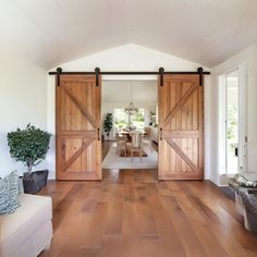 a living room filled with furniture and sliding doors