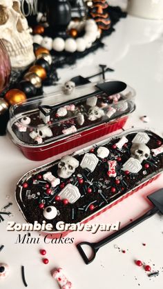 two trays filled with halloween treats sitting on top of a white table next to each other