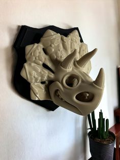 a sculpture of a rhino's head on a wall