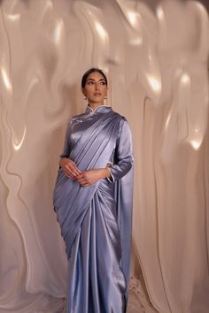 Here is Kanyä London's light blue Chinese Cheongsam-inspired saree. Made from the most luxurious silk, it will give you a sophisticated look. Perfect for an evening event. Click the pin to find out more! | #saree #cheongsam #asianwear #indianwear #southasian #eid #modestwear #ramadan #desi #elegant Long Sleeve Saree, Light Blue Saree, Blue Silk Saree, Chinese Cheongsam, Blue Saree, Modest Wear, Satin Blouses