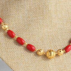 Gold Dangling Beads For Festivals, Elegant Red Coral Necklace With Gold Beads, Gold Beaded Necklaces With Red Coral Round Beads, Gold Necklace With Polished Red Coral Beads, Gold Beaded Necklace With Polished Red Coral, Elegant Red Coral Beaded Necklace With Gold Beads, Red Coral Necklace With Gold Beads For Gift, Traditional Gold Necklaces With Red Coral, Gold Necklaces With Colorful Oval Beads