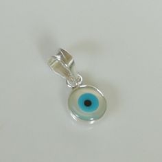 ▪︎ Tiny sterling silver evil eye charm/ pendant. ▪︎ Size: 6 x 9 mm Jump ring: 5 mm ▪︎ This is a multi functional charm and can be used with neck chains, ear hoops, bracelets, anklets, key chains etc. ▪︎ This pendant is handmade with hypoallergenic sterling silver, and is nickel free. Comes with a 925 mark for authenticity. ▪︎ Please note: Price listed is for ONE charm. This pendant comes WITHOUT the chain, however, you can add a snake neck chain, bracelet chain or hoop in the required size while Handmade Spiritual Charms As Gifts, Silver Round Pendant Spiritual Charm, Handmade Sterling Silver Dangle Charm Necklaces, Handmade Sterling Silver Dangle Charm Necklace, Handmade Spiritual Silver Charms, Hypoallergenic Pendant Charm As A Gift, Hypoallergenic Pendant Charms For Gifts, Silver Amulet Style Charm Necklace With Large Pendant, Silver Symbolic Charm Necklace With Round Pendant