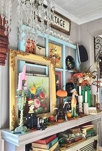 a mantle with pictures and other items on it in a room that is decorated for halloween