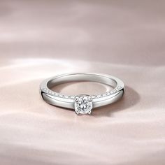 Simple and stunning, this ring showcases a magnificent round cut stone standing tall in the traditional four-prong setting, while additional round stones line the shank. So elegant it needs no further accompaniment, this ring is finished with a bright polished shine. The stones in this engagement ring shine brightly enough to be deserving as a symbol of your love.Carat Weight: 0.275 ctStone Size: 4 mmStone Type: Jeulia® StoneNumber of Stones: 1 Stone Color: Diamond WhiteStone Shape: RoundCarat Weight: 0.648 ctStone Size: 1.1,1.3,1.5 mmStone Type: Jeulia® StoneNumber of Stones: 32 Stone Color: Diamond WhiteStone Shape: RoundWeight: 2.7 gWidth: 1.7 mmHeight: 4.9 mmThickness: 1.2 mmMaterial: 925 SilverPlating Color: Silver Round Cut, Quality Jewelry, Prong Setting, Stone Color, Sterling Silver Rings, Silver Rings, Engagement Rings, Sterling Silver, Stone