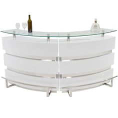 a white curved counter with wine glasses on top