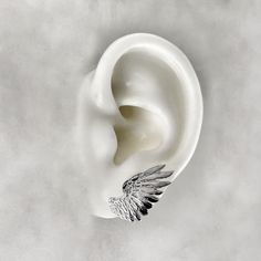 Wearing these Angel Wing Earrings serves as a reminder that guardian angels watch over us, offering protection and guidance. Let the ethereal beauty of the angel wings inspire you and add a touch of grace to your everyday life. Whether you wear them as a personal talisman or as a symbol of faith, these earrings will uplift your spirits and ignite a sense of connection to the divine. Each wing measures 2.5cm. Material : 925 Sterling Silver, 24k Gold Plate. Each piece is handmade to order in the Jewel Thief Brighton atelier. Elegant Metal Wing-shaped Earrings, Elegant Wing-shaped Metal Earrings, Pierced Winged Earrings As Gift, Handmade Silver Wing-shaped Earrings, Elegant Silver Winged Earrings, Silver Wing-shaped Earrings, Angel Wing Ear Cuff, Angel Wings Gold, Memento Mori Ring