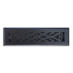 an ornate design is shown on the side of a black tile wall mounted in a white background