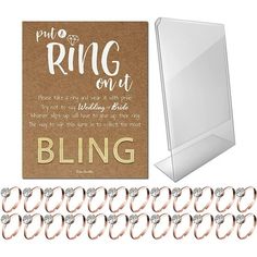 the ring on it is being displayed next to several pairs of wedding rings and a card