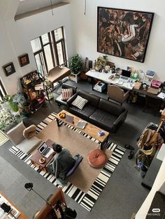 an overhead view of a living room with couches, chairs and paintings on the wall