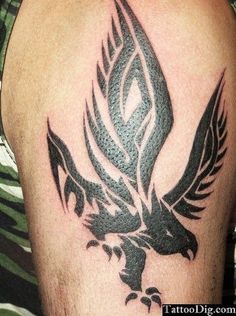 an eagle tattoo on the back of a man's arm