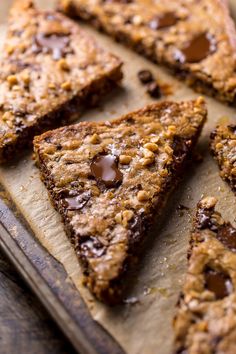 chocolate chip cookie bars sitting on top of a wooden cutting board