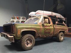 a toy truck with a surfboard on top of it