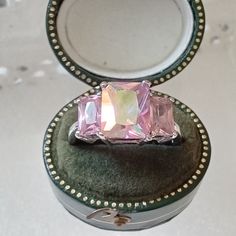 Beautiful iridescent pink crystal dress ring by Kirks Folly. Safely claw set stones set on silver plated mount. Signed inside the band. Kirks Folly made whimsical designs influenced by themes from fantasy and story books. The company folded in 2014 and the pieces have become very sought after. This ring is in very nice condition. Size P and 1/2 (UK sizing) . Presented in eco friendly gift box shown in last photo. All other boxes etc in photos display only. More rings to choose from at  https://g Pink Sterling Silver Crystal Ring For Formal Occasions, Pink Rings With Sparkling Stones For Formal Events, Pink Gemstone Party Ring, Elegant Pink Crystal Ring For Party, Elegant Iridescent Rings For Parties, Silver Topaz Gemstone Ring For Party, Sparkling Glamorous Ring For Gift, Glamorous Sparkling Ring For Gift, Glamorous Sparkling Gift Ring