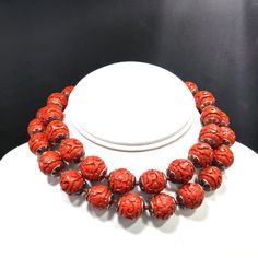 *Description: This beautiful vintage Chinese export hand carved beaded necklace from the 1960s which measures 29 inches long. The beads are all in great condition and are 16 mm. They have silver tone bead caps with red enamel designs. These beads are carved in a floral pattern. Each bead is hand knotted with red silk. A beautiful filigree gold tone clasp accents the necklace. This would be a great addition to your vintage jewelry collection or make a great vintage gift! *Approximate Measurements Vintage Carved Beaded Necklaces As Gifts, Vintage Single Strand Red Coral Beaded Necklaces, Unique Carved Beaded Necklace, Vintage Red Jewelry With 8mm Beads, Vintage Red Necklaces With Colorful Beads, Vintage Red 8mm Beaded Jewelry, Vintage Red Coral Round Bead Necklaces, Vintage Red Coral Necklace With Round Beads, Vintage Red Necklace With Colorful Beads