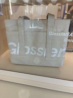 the glass case is holding an old bag in it's display window sill