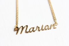 This is a very awesome vintage name necklace. This necklace measures 16" long and the name measures about 1.5" wide total. This is 14k gold plated.Model shown wearing “Marie” name necklace.NOTE: This CAN NOT be custom made. They are vintage, thus you will receive the exact same name in the photo above. We have lots of vintage name jewelry in the shop! You can see them all here at this link:https://www.etsy.com/shop/diamentdesigns/search?search_query=name&order=date_desc&view_type=gallery&ref=sho Vintage Silver Name Necklace, Vintage Personalized Nameplate Necklace, Personalized Vintage Nameplate Necklace, Vintage Custom Name Jewelry Nameplate, Vintage Nameplate Necklaces, Vintage Custom Nameplate Jewelry, Vintage Custom Name Nameplate Jewelry, Vintage Gold Name Necklace, Vintage Gold Necklace With Name Detail