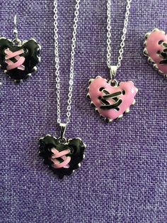 "(18,031) Corset Hearts Necklace and Earrings  Stainless enamel, 3/4\" x 7/8\" Earrings on silver plate ear wires Necklace on 16\" silver plate chain" Emo Heart-shaped Jewelry For Valentine's Day, Punk Heart Necklace For Valentine's Day, Punk Style Heart-shaped Earrings As Gift, Black Punk Heart Pendant Jewelry, Gothic Heart-shaped Necklace For Valentine's Day, Hearts Necklace, Jewellery Sets, Wire Necklace, Pink Necklace