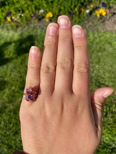 The Hempstead Bubblegum Ruby & Diamond Cocktail Ring. The ring features a reddish purple sapphire center stone with vivid red natural rubies and pink sapphires cascading from the center. Mixed between are diamonds throughout. The ring contains approximately 2 carats total weight by measurement of rubies and sapphires. The total estimated diamond weight by measurement is 0.36 carats. The ring is crafted in 14 karat yellow gold and is currently a finger size 6 yet can be adjusted to any finger Red Ruby Diamond Multi-stone Ring, Red Ruby Multi-stone Ring With Diamonds, Pink Diamond Cluster Ring With Multi-stone, Formal Pink Ruby Ring, Pink Lab-created Ruby Ring, Pink Ruby Diamond Ring With Multi-stones, Cluster Ruby Ring With Center Stone, Red Ruby Cluster Ring With Round Cut, Red Ruby Cluster Ring With Center Stone