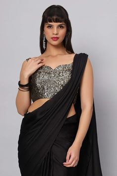 This Antique Gold sequins on Black georgette blouse is a stunner. A touch of modern with a timeless appeal, pair it with your favorite black saree! Product Features: Color: Black Fabric: Sequin on Georgette Design - Sweetheart Front, Deep Leap back with tassels Sizing: Not stretchable - margin of 2 inches inside seams for adjustments Occasion: Party, Wedding, Bridesmaid, Festive Product Type: Blouse Disclaimer: There will be slight difference in digital to actual image Sequins Belt, Black Sequin Blouse, Gold Sequin Blouse, Saree Drapes, One Minute Saree, Sequins Blouse, Silver Blouse, Gold Jacket, Sequin Blouse