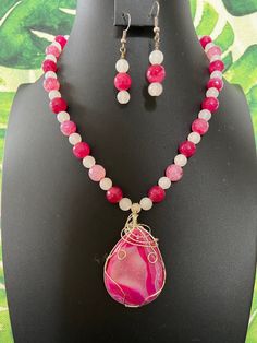 You will receive a gorgeous, hot pink and white, banded agate pendant and beaded necklace with matching earrings. This expertly-wrapped pendant is visually stunning. It is a flatback, but the back is very pretty, too.  I have strung this pendant entirely with round, agate beads.  The pinks are faceted, and some are banded, while others are crackled. The white agate spacers are simply round. I do have other pink agate necklaces listed, so be sure to check the others out and choose the one you lik Agate Jewelry Diy, Pink Gemstone Bead Pendant Jewelry, White Agate Beaded Necklace For Gifts, White Agate Jewelry With Polished Beads, Pink Agate Gemstone Jewelry, Pink Agate Beaded Necklaces As Gift, Pink Agate Beaded Necklaces With Round Beads, Pink Agate Beaded Necklace With Round Beads, Pink Polished Beads Spiritual Jewelry