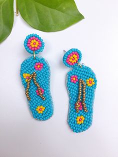 This turquoise beaded flip flop earrings is just the most cutest thing you set your eyes on. 2.5 inches Summer Beach Beaded Earrings, Fun Beaded Dangle Earrings For Beach, Fun Beaded Earrings For Beach In Summer, Handmade Beaded Earrings For Beach In Summer, Fun Drop Earrings For Beach, Colorful Beaded Earrings For Beach In Summer, Fun Beaded Earrings For Beach, Colorful Beaded Earrings For Summer Beach, Fun Beaded Earrings For The Beach