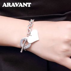 Product Features: The Aravant 925 Silver Heart Bracelet Chain features an intricately crafted heart design, exuding timeless elegance and sentiment. Crafted from premium 925 sterling silver, the bracelet ensures durability, tarnish resistance, and a lustrous finish. Equipped with a secure clasp, the bracelet ensures a snug and worry-free wear. Ideal for daily wear or special occasions, the bracelet complements various styles and outfits. The heart design symbolizes love and affection, making thi Elegant White Gold Heart-shaped Chain Bracelet, Elegant Silver Heart Chain Bracelet, Elegant White Gold Chain Bracelet For Valentine's Day, Classic White Gold Heart Bracelet As Gift, Elegant Chain Bracelet For Anniversary And Mother's Day, Valentine's Day Gift Elegant Chain Bracelet, Silver Heart Bracelet For Wedding On Valentine's Day, Classic Bracelets For Anniversary On Valentine's Day, Elegant Silver Heart Bracelet As Gift