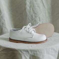 The Harvey Oxford is made of white full grain leather and lined with breathable leather and cotton which work together to draw out any moisture. The structure of the shoe and the rubber sole provide stability without weight to support your child's early steps. The perfect style to dress up or down! Classic White Lace-up Leather Shoes, White Leather Lace-up Shoes With Textured Sole, Classic Walking Shoes With White Rubber Sole, White Walking Shoes With Rubber Sole For Everyday Use, Everyday White Walking Shoes With Rubber Sole, White Non-slip Lace-up Walking Shoes, White Leather Walking Shoes With Rubber Sole, White Low-top Walking Shoes With Stitched Sole, White Lace-up Leather Shoes With Textured Sole