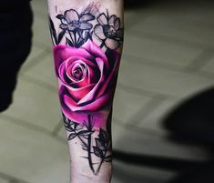 a person with a rose tattoo on their arm