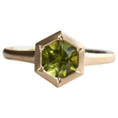 Solid 14k gold with hexagon shaped peridot stone. Matte finish August birthstone Bead setting White gold and rose gold available. Stone: Approx 6mm Measurement band width 1.8mm bottom, 2.3mm top LEAD TIME: Made to order will take 10-14 days. All of our jewelry will arrive in custom packaging ready for gift giving. FOLLOW US ON: Instagram: @roseandchoc Facebook: /Roseandchoc Pinterest: @Roseandchoc Yellow Gold Peridot Jewelry With Emerald Cut, Green Octagon Solitaire Jewelry, Green Octagon Birthstone Jewelry, Yellow Gold Octagon Faceted Rings, Green Octagon Diamond Cut Ring, 14k Gold Hexagon Gemstone Ring, Hexagon 14k Gold Gemstone Ring, Green Octagon Ring With Bezel Setting, Hexagon 14k Gold Rings With Gemstone