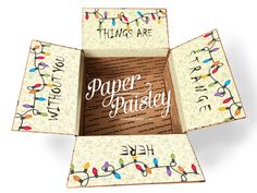 an open box with string lights on it that says paper poisey and the words,