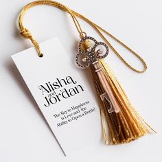 a tasseled bookmark with a key on it