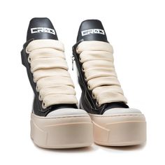 Color: Combination of black and white Material: Made of leather Sole: High and thick in a beige color, featuring a layered design that adds height Closure: With thick beige laces that provide a contrasting look against the body of the shoe Design: The shoe has a high-top boot design with visible white stitching that outlines the leather sections Logo: A distinctive logo is visible on the top part of the tongue Details: The shoe features padded support on the heel and around the ankle for comfort Boot Design, Contemporary Streetwear, High Top Boots, Shoe Design, Bold Style, Layered Design, Designer Boots, Emphasis, Layers Design