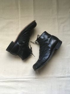 "1920s men's ankle boots work wear black leather leather sole steel toe cap toe 10 eyelet- top 4 hook Good Year Wing Foot heel cap brown leather lined felt lined tongue steel arch good vintage condition, light wear light marks, fade, scuffs, nicks-esp. toes (see photos) marked size 8, see below measures, insole-10 3/4\" sole-11 3/4\" width-4 1/4\" heel-1 1/2\" total height-6\"" Vintage Work Boots With Rubber Sole For Fall, Vintage Black Plain Toe Boots, Vintage Combat Boots With Leather Sole, Vintage Combat Ankle Boots With Leather Sole, Vintage Combat Boots With Snip Toe And Leather Sole, Vintage Lace-up Cap Toe Boots With Leather Sole, Fitted Leather Sole Work Boots With Round Toe, Vintage Lace-up Boots With Cap Toe And Leather Sole, Vintage Lace-up Goodyear Welted Work Boots