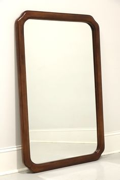 a mirror sitting on the floor next to a wall