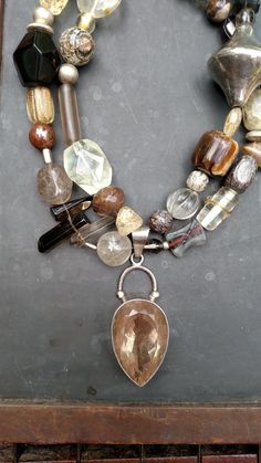 Walk that walk like the  fashionista you are..a fun neutral piece to compliment any outfit.  A large quartz pendant is surrounded by various sizes and shapes of quartz beads. Agate, jasper and crazy horse are also added.  Be individual..make a statement! Measures 18 inches. Hook closure. #yourjewelryshouldmakeyousmile Item # 370 Gem Stone Necklace, Large Bead Necklace, Art Statement, Diy Jewelry Necklace, Art Necklaces, Bracelet Display, Chunky Jewelry, Jewelry Boho, Gem Stone