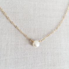 This is a single pearl necklace made of genuine high quality fresh water pearl. This fresh water pearl necklace is light weight and elegant. This tiny pearl necklace is around 5mm. This pearl necklace is great for layering with other gold necklaces. Pearl is June birthstone. Measurement: 5mm fresh water pearl S for Sparkle on Etsy https://www.etsy.com/shop/sforsparkleshop -------------------------------------------------------------------- S for Sparkle Mission We believe that everyone should ha Simple Pearl Chain Necklace As Gift, Simple Pearl Necklace Gift, Simple Pearl Necklace For Gift, Simple Pearl Drop Necklace For Gifts, Minimalist Pearl Drop Necklace With Round Beads, Minimalist Pearl Necklace With Pearl Pendant, Simple Pearl White Pearl Jewelry, Minimalist Pearl White Necklace With Pearl Drop, Simple Pearl Necklace With Clavicle Chain As Gift