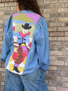 Made using a quality puff-sleeve denim shirt and a vintage cowboy printed quilt, this shirt is the perfect statement piece. Women's size L but will fit many sizes. Western Quilts, Quilted Shirt, Cowboy Quilt, Quilt Shirt, Vintage Cowboy, Denim Patches, Denim Shirt, Cowboy, Womens Sizes