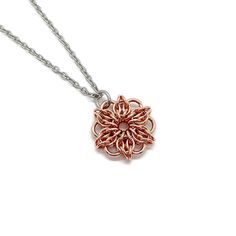 Copper, which has long had a traditional meaning of prosperity, good luck, and good fortune, is the traditional material for the 7th wedding anniversary. This handmade pendant is made with solid copper jump rings in a Celtic mandala design. The included chain is an 18-inch 2mm stainless steel cable chain with stainless steel lobster clasp. Stainless steel resists rust, tarnish, oxidation, discoloration and corrosion, and is very strong. The chain will not oxidize during wear, and it is not plate Rose Gold Jewelry With Large Pendant As Gift, Gift Jewelry In Bronze Copper, Handmade Rose Gold Copper Jewelry, Anniversary Rose Gold Copper Jewelry, Red Copper Jewelry For Gifts, Bronze Copper Jewelry Gift, Red Copper Jewelry Gift, Bronze Copper Jewelry As A Gift, Gift Bronze Copper Jewelry