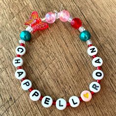 a beaded bracelet with beads and charms that spell out the word bleal