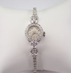 "Vintage Antique Art Deco HAMILTON Watch, dating back to the 1920's. Hand wound Mechanical movement in perfect working condition with a power reserve of approximately 30 hours per wind. The watch is crafted in a 14 Karat White Gold. Both the watch case and the bracelet are white gold and set with genuine Round Diamonds. There are sixty-one genuine round diamonds and two Marquise Diamonds set in the watch case the bracelet band. These diamonds are G in color, SI/VS in clarity and combine to a total weight of 2 1/4 carats. The watch weighs 16.4 grams and measures 6\" in length. This watch will ship promptly in a gift box (not original box), accompanied by an appraisal, valued at $6,495.00. ADDITIONAL REQUESTS If you would like to see more pictures of this item, please let us know and we woul Luxury Wedding Jewelry And Watches With Bracelet Strap, Luxury Vintage Diamond Watch With Subdials, Luxury Timeless Diamond White Watch, Luxury Victorian Style Watch, Luxury Victorian Style Watch With Round Dial, Luxury Vintage Silver Watch Accessories, Luxury Antique Formal Watch Accessories, Luxury Vintage Rectangular Watch Accessories, Classic Formal Jewelry And Watches With 17 Jewels