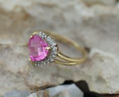 This is the perfect option for those who like cool, unique jewelry and the luxury, shine of gold, pink, clear. This ring is well made, cute and/or elegant in design, and very desirable. The size of the ring is 7. The ring is decorated with a pink natural stone and diamond on the top. The stone has a shape of the heart. ♥ Age/Era: Circa before the 2000s. ♥ There is a hallmark, 10K. HV. ♥ The weight is 2g. Everyone interested in the jewelry should remember that he or she must like their jewelry- n Pink Heart-shaped Rings For Formal Occasions, Pink Pear-shaped Diamond Jewelry, Fine Jewelry Heart Cut Pink Jewelry, Pink Rings With Diamond Accents For Promise Occasion, Pink Rings With Diamond Accents For Promise, Pink Diamond Accented Promise Rings, Pink Diamond Accents Promise Rings, Pink Rings With Halo Setting For Valentine's Day, Pink Brilliant Cut Jewelry For Promise