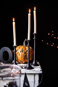 an instagram with candles, pumpkins and other decorations on it's table