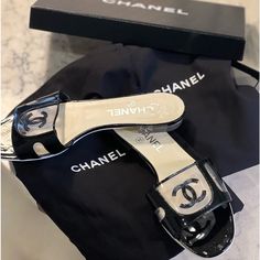 These Chanel Mules Are Black Patent With Pvc. Size 38 In Great Condition. Wear Only To Bottom As Only Worn A Few Times. Perfect For Any Outfit. Comes With Dust Bag For Each Shoe And Box. Chanel Mules, Shoes Chanel, Chanel Black, Chanel Shoes, Mule Clogs, Mules Shoes, Clogs, Slides, Dust Bag