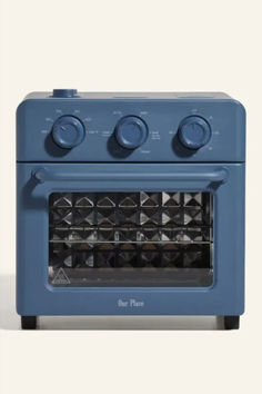 a blue stove top oven with four burners and knobs on the front door