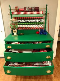 a green dresser with christmas wrapping on it