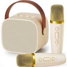 two microphones are next to an old style speaker and another item is in front of it