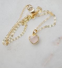 Looking for a unique accessory for some self love, or love for that special someone? Crafted from 14k gold filled and natural Rose Quartz, this pendant is the perfect, sparkling way to show anyone how much you care. Rose Quartz is a stone of love. It is believed to restore trust & harmony in relationships and encourage unconditional love. It purifies the heart and promotes self love, inner healing, and friendship. It is an alternate birthstone for January, as well as the spiritual birthstone for Dainty Birthstone Jewelry For Valentine's Day, Minimalist Gemstone Jewelry For Valentine's Day, Tiny Heart Pendant Jewelry For Valentine's Day, Gold Rose Quartz Pendant Jewelry, Delicate 14k Gold Filled Jewelry Gift For Mom, Delicate 14k Gold Filled Jewelry For Mom, Dainty Rose Gold Jewelry With Heart Charm, Delicate Pink Gold Jewelry With Gemstone, Valentine's Day Tiny Heart Pendant Jewelry